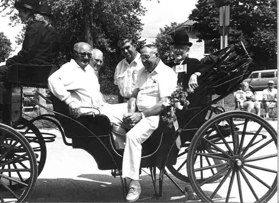 Old photo of men in an old horse-drawn carriage
