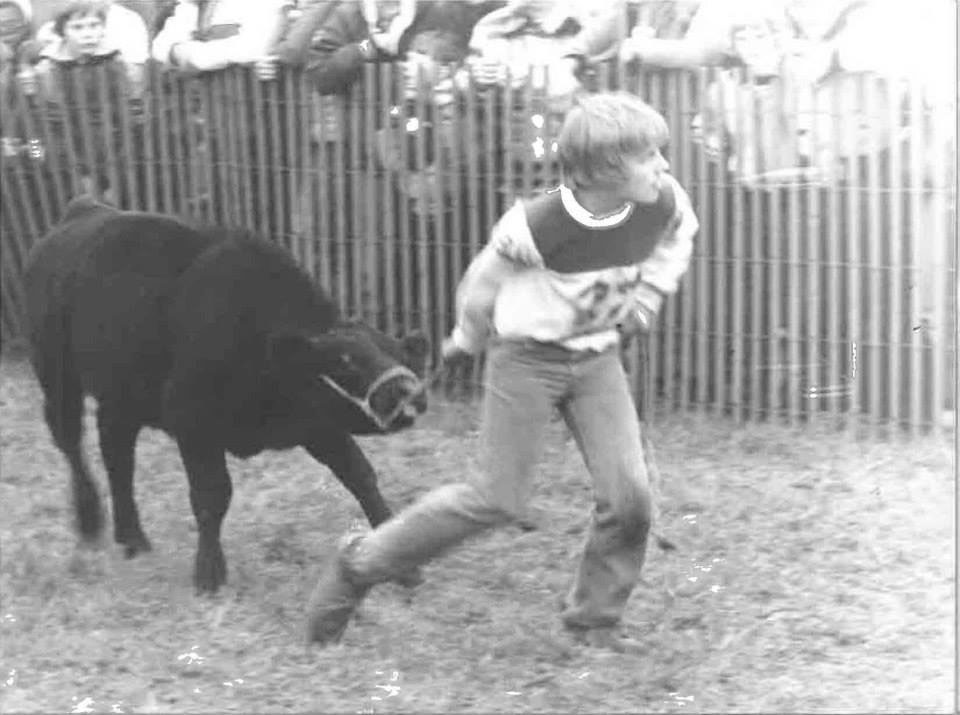 Old photo of teen boy with a cow
