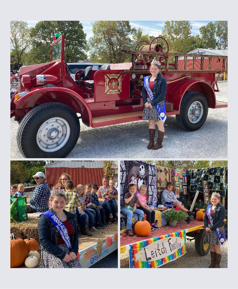 Fair Ambassador posing with fire truck and parade floats