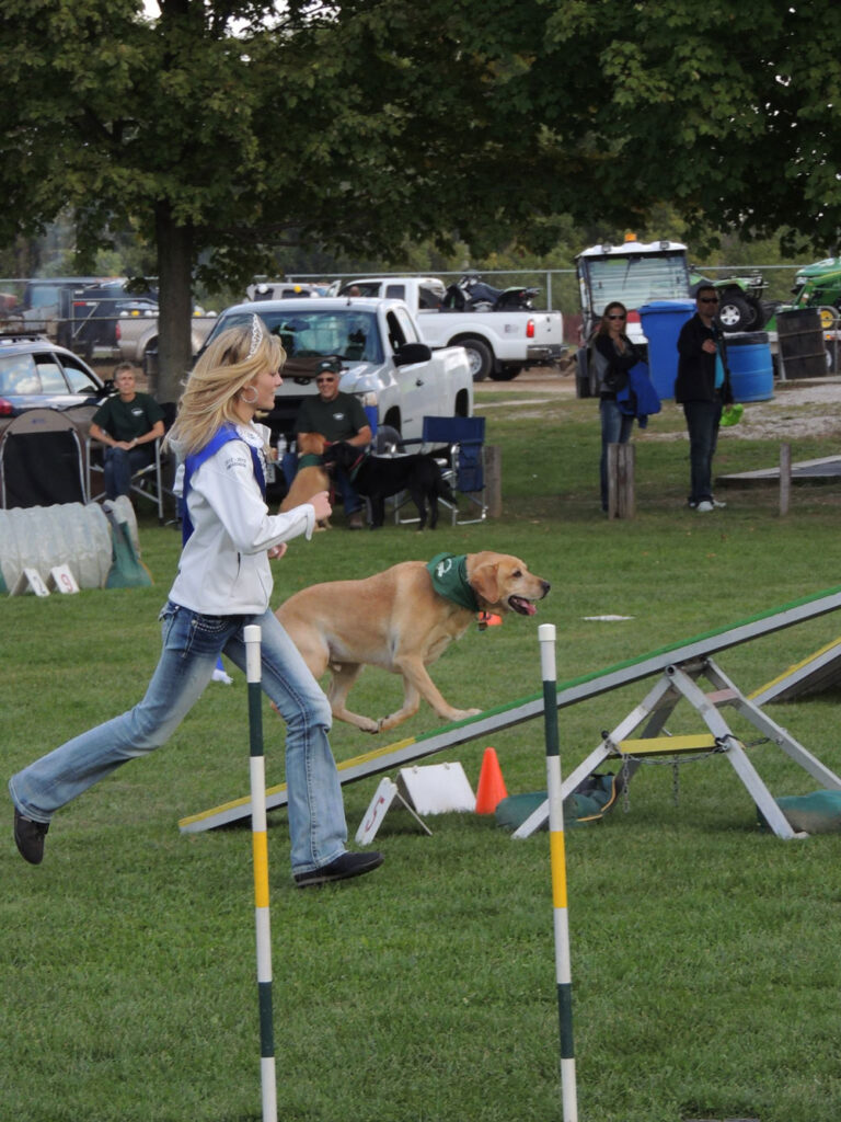 Fair Ambassador running with dog